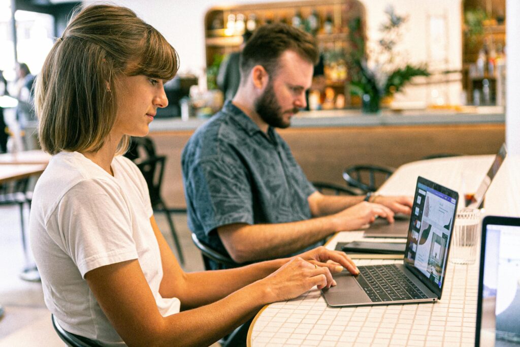 A Mastering Freelance Marketing team working with laptops